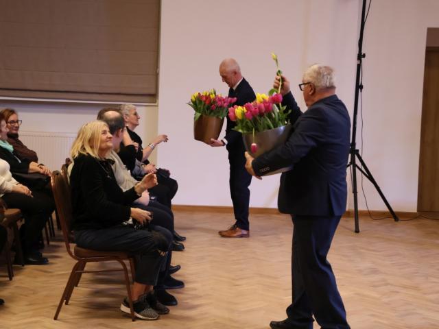 Wójt gminy Włoszakowice Robert Kasperczak i sołtys Bukówca Tadeusz Malepszy wręczają tulipany obecnym kobietom